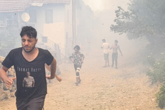 People evacuate after a wildfire swept through the village of Voden amid a heat wave in Bulgaria on July 17, 2024. Credit: Ivan Yanev/Bgnes News Agency/AFP via Getty Images