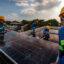 Workers install solar panels on the roof of a house in Antipolo, Philippines. Credit: Ezra Acayan/Getty Images