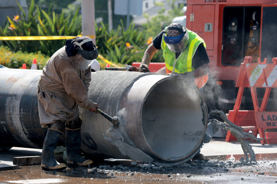 Crews prepare a replacement pipe as they repair a water main in West Hollywood, Calif., on July 17. Credit: Myung J. Chun/Los Angeles Times via Getty Images