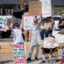 Demonstrators wave signs during a protest against AI data center development in rural Imperial, Calif., on July 18. Credit: Sandy Huffaker/AFP via Getty Images