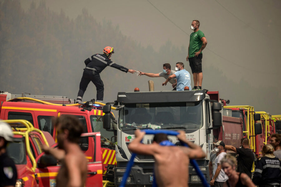 Volunteers help firefighters combat a wildfire in Lanton, west of Bordeaux, in southwestern France on July 29. Credit: Ed Jones/AFP via Getty Images