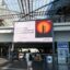 Passengers walk past a heat-warning display at the main train station in Berlin, Germany's capital, on July 30, 2026 / Getty Images