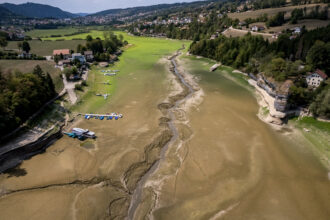 Boats are left stranded on a dried-up river on the border of France and Switzerland during a heatwave in Europe on Aug 11. Credit: Fabrice Coffrini/AFP via Getty Images