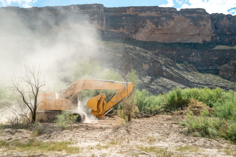 An excavator plows through land during construction for a section of the border wall on Aug. 14 in Big Bend National Park. Credit: Brandon Bell/Getty Images