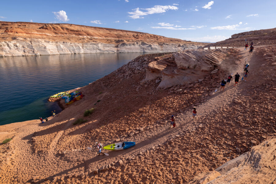 Kayakers descend a trail from a boat ramp at Antelope Point that now ends hundreds of feet from Lake Powell on Aug. 20 near Page, Ariz. Credit: David McNew/Getty Images