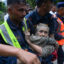Rescue workers help a resident affected by flash floods in Nepal’s Nuwakot district on Aug 26. Credit: Prakash Mathema/AFP via Getty Images