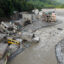 Muddy water surges past houses and through the Trishuli river in the aftermath of flash floods in Nepal’s Nuwakot district on Aug. 29. Credit: Prabin Ranabhat/AFP via Getty Images