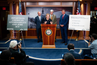 Sen. Shelley Moore Capito (R-W.Va.), joined by Sen. Mike Lee (R-Utah), Sen. Sheldon Whitehouse (D-R.I.) and Sen. Martin Heinrich (D-N.M.), announces the Bipartisan American Affordability and Jobs Act during a press conference on Wednesday. Credit: Bill Clark/CQ-Roll Call via Getty Images