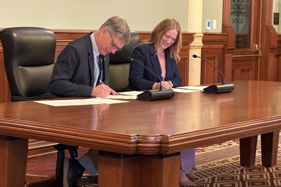 Gov. Mark Gordon and Federal Permitting Improvement Steering Council Executive Director Emily Domenech sign a memorandum of understanding on Oct. 26, 2026 "to prevent unnecessarily long reviews for critical infrastructure projects."