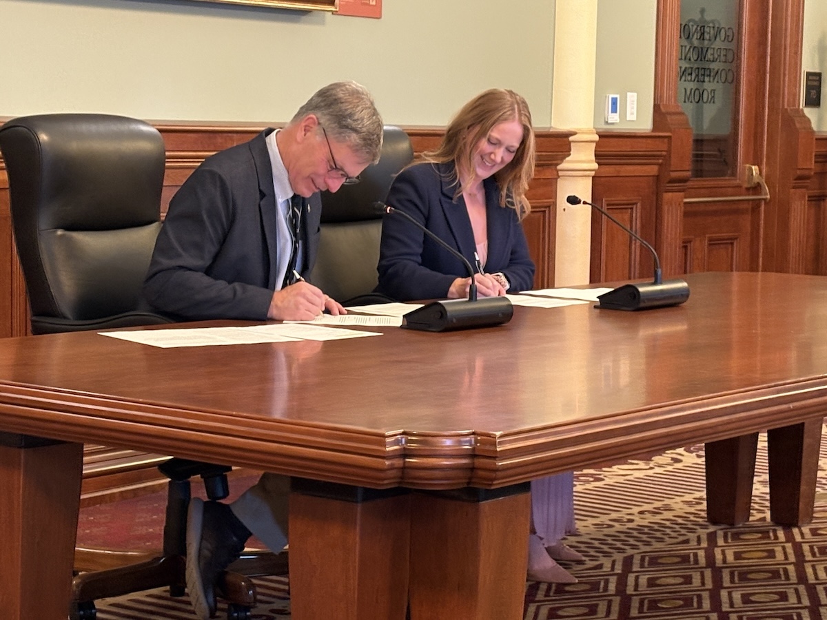 Gov. Mark Gordon and Federal Permitting Improvement Steering Council Executive Director Emily Domenech sign a memorandum of understanding on Oct. 26, 2026 "to prevent unnecessarily long reviews for critical infrastructure projects."