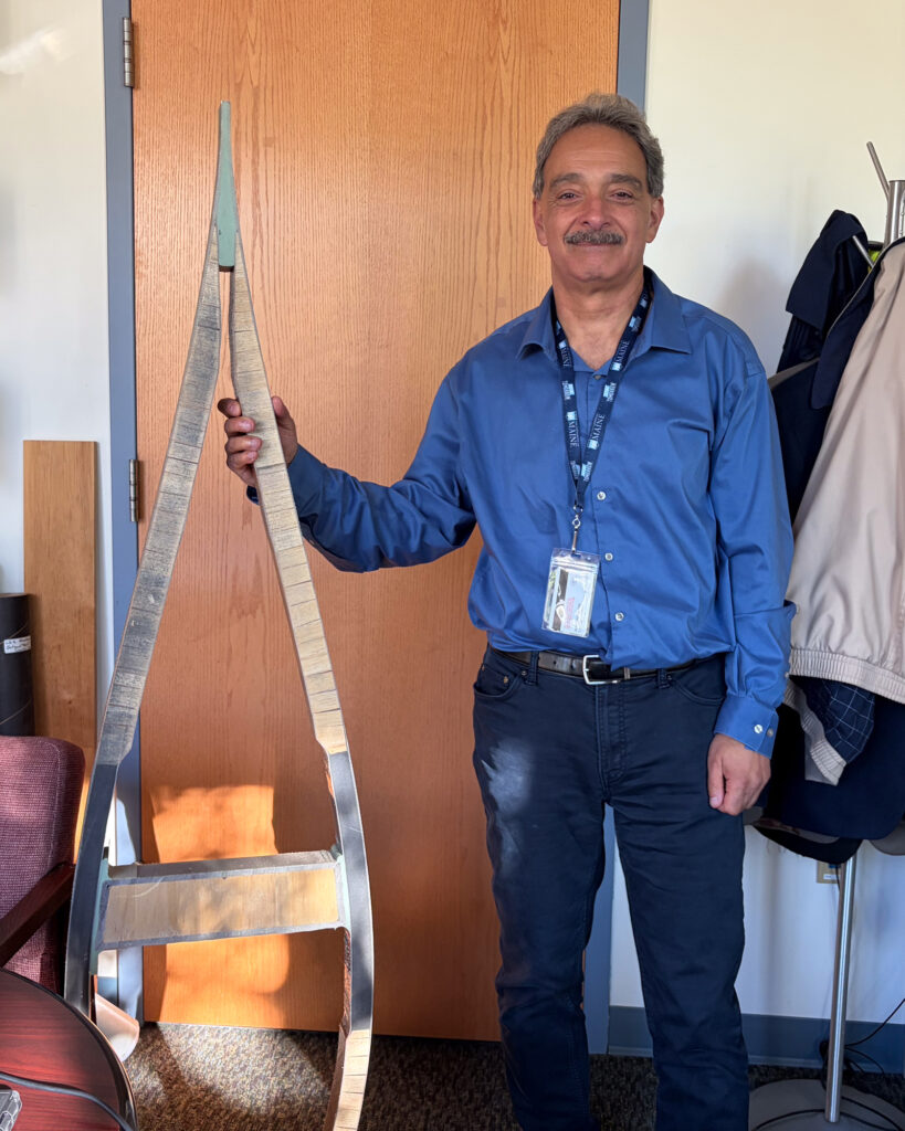 Habib Dagher displays a miniature turbine blade frame in his office at the University of Maine. Credit: Nathaniel Eisen/Inside Climate News