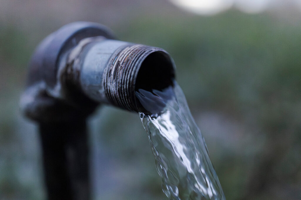 Water from a natural spring pours out of a pipe in San Luis, Colo., on May 5. Credit: Jacob Spetzler/Inside Climate News