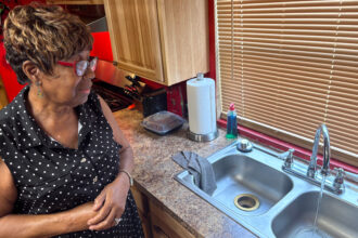 Ann Jones says the water at her home in Whitted, Fla., runs clear only some of the time. Other times, the water is brown. Credit: Amy Green/Inside Climate News