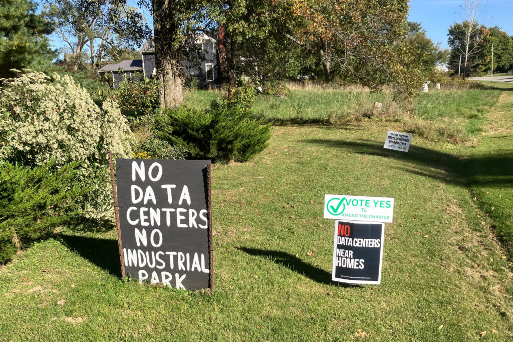 Signs in Alicia Doty’s front yard show her views on data centers. Credit: Dan Gearino/Inside Climate News