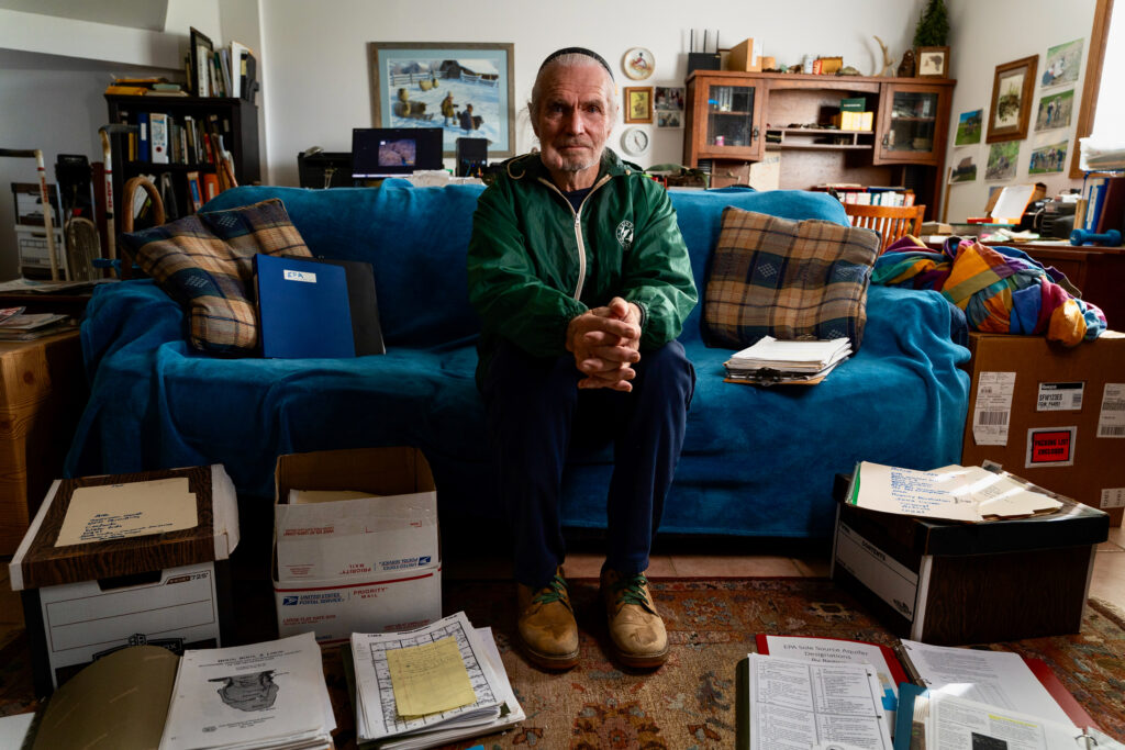 Gordon Garrison sits in his home, surrounded by records from his lawsuits against New Fashion Pork. The suits were dismissed in summary judgements from both federal and state judges.