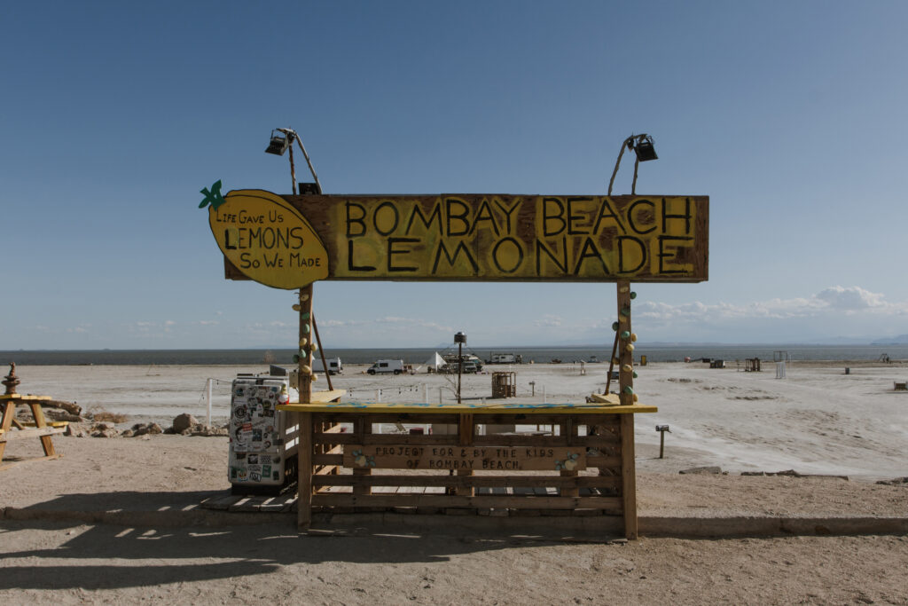 A handmade “Bombay Beach Lemonade” stand overlooks the Salton Sea in Bombay Beach, Calif., once a popular resort destination. Credit: Carla Samon Ros/CJI