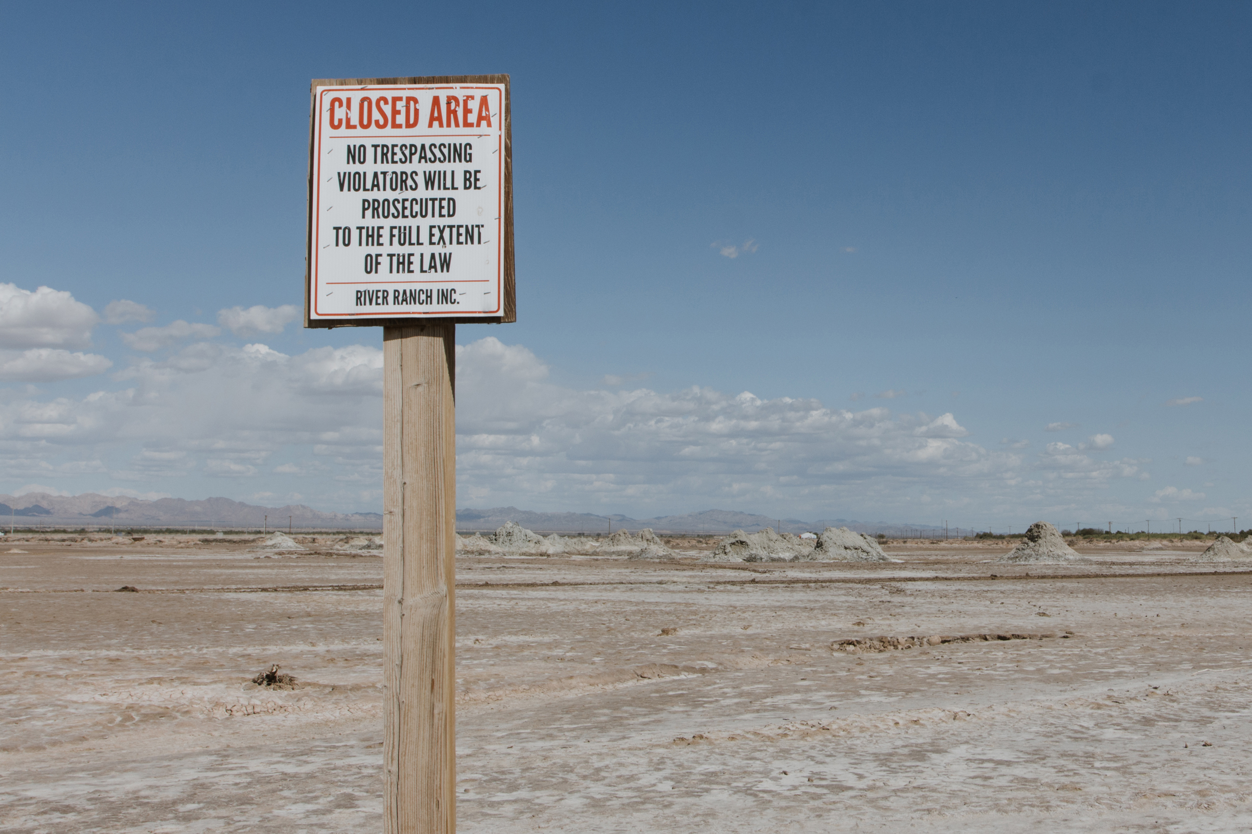 A “No Trespassing” sign marks a field near the southeastern shore of the Salton Sea, where geothermal activity creates mud pots and mud volcanoes. The site lies within a broader landscape that holds religious and cultural significance for several Indigenous peoples. Credit: Carla Samon Ros/CJI