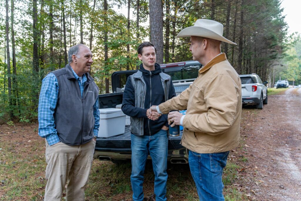 Fenn Church, left, speaks with Rep. Phillip Ensler, center, and lawyer Jay Welborn. Photo credit: Lee Hedgepeth/ Inside Climate News