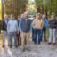 Fenn Church, center, is flanked by supporters at the gate of his property in Shelby County, Alabama. Photo credit: Lee Hedgepeth/ Inside Climate News